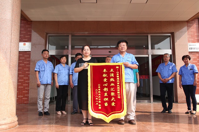 山东省献血办公室王淑荣主任向山东银鹰炊事机械有限公司焦念雷董事长赠送“点滴热血汇聚大爱、奉献彰显担当”锦旗.jpg